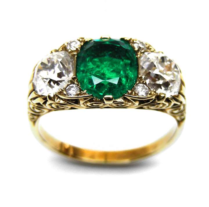 Emerald and diamond three stone carved gold half hoop ring